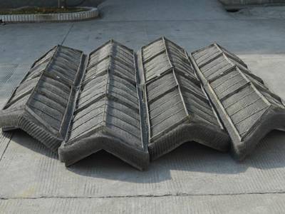 There is a wave type wire mesh demister placed on the ground.