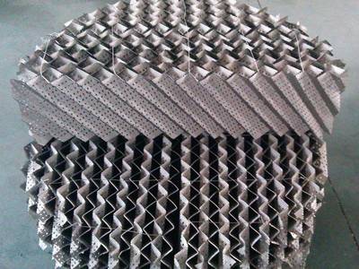 A half piece of metal perforated plate corrugated packing is placed on a integral one.